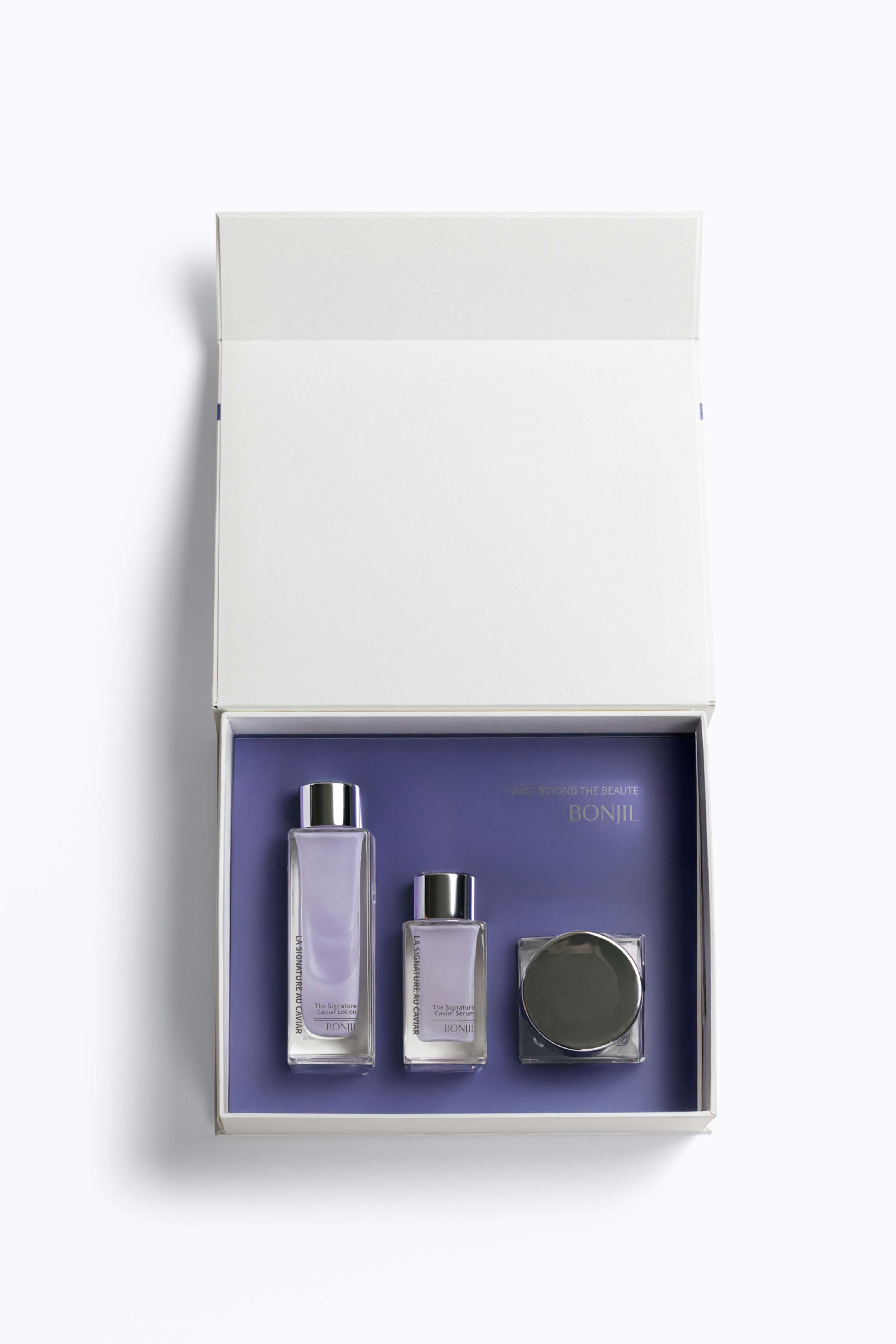 Set of skincare products in a white box with a purple interior